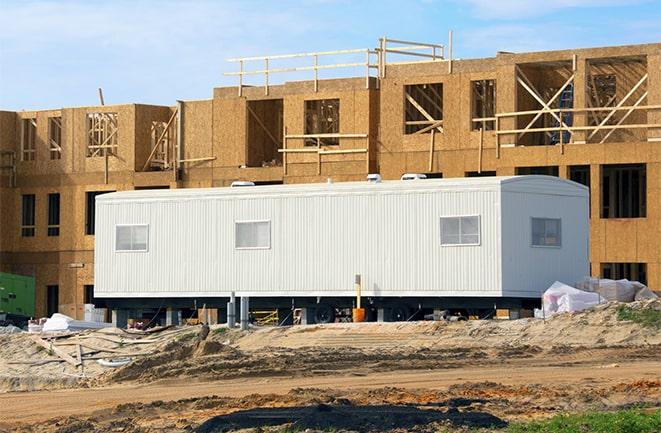 crane lifting modular building for construction office rentals in Madison